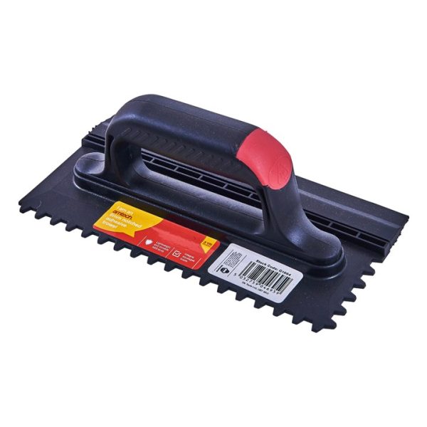 Notched adhesive trowel with squeegee blade